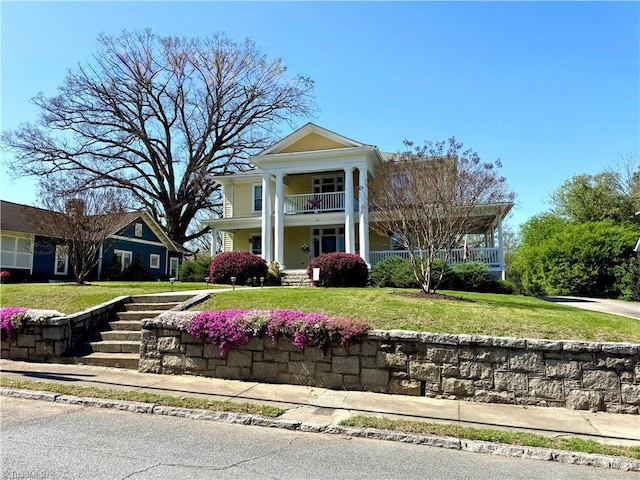 311 Cherry St, Mount Airy, NC 27030 - neoclassical home with a porch, a balcony, and a front lawn