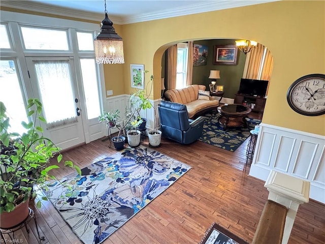 311 Cherry St, Mount Airy, NC 27030 - living area featuring a chandelier, arched walkways, wainscoting, wood finished floors, and crown molding