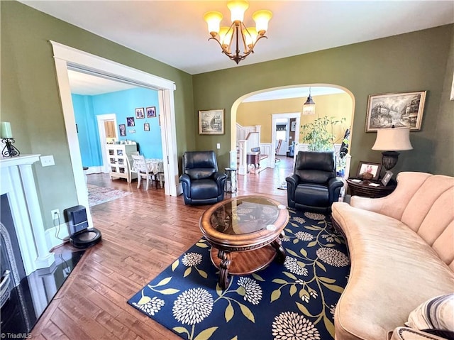 311 Cherry St, Mount Airy, NC 27030 - living room featuring arched walkways, wood finished floors, and a chandelier