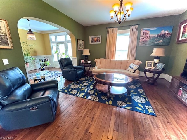 311 Cherry St, Mount Airy, NC 27030 - living room with arched walkways, hardwood / wood-style floors, a chandelier, and a wainscoted wall