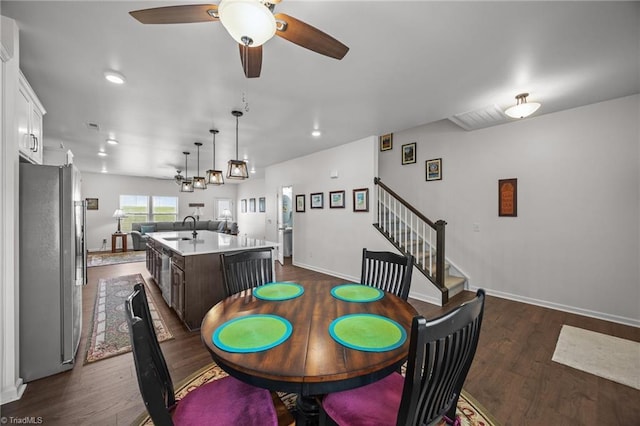 dining space with dark wood-style flooring, ceiling fan, stairway, baseboards, and recessed lighting