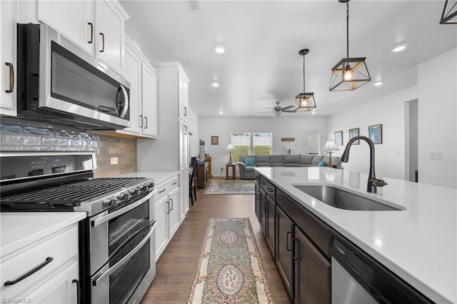 kitchen featuring stainless steel appliances, a sink, light countertops, ceiling fan, and recessed lighting