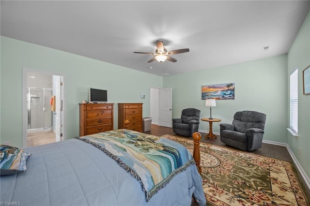 bedroom featuring baseboards, ceiling fan, and ensuite bathroom