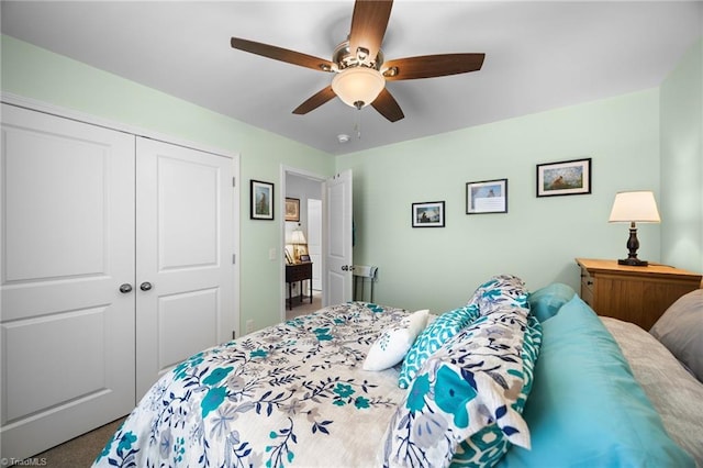 carpeted bedroom with a closet and ceiling fan