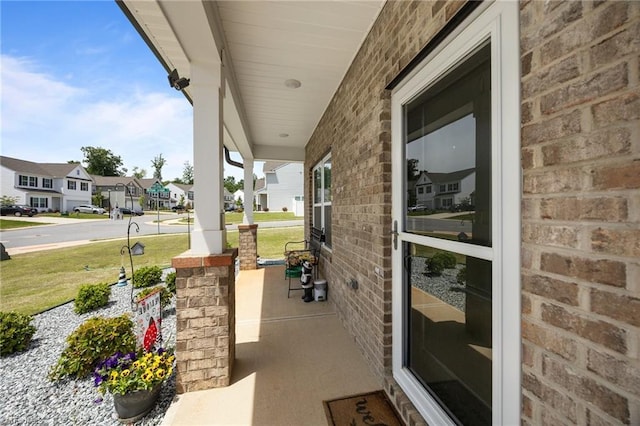 view of patio / terrace featuring a porch and a residential view