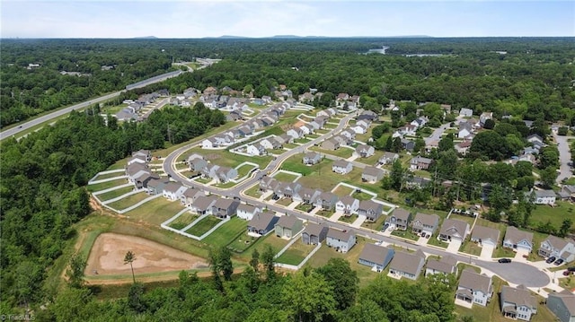 aerial view of property's location featuring a forest