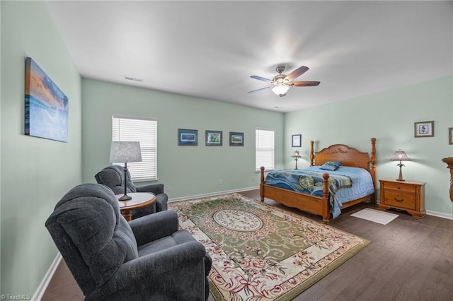 bedroom with baseboards, dark wood-style flooring, and a ceiling fan