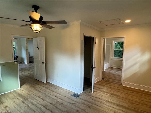 spare room featuring ornamental molding, ceiling fan, and light hardwood / wood-style flooring