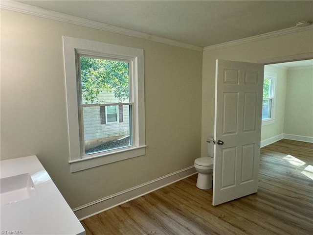 bathroom with ornamental molding, toilet, vanity, and hardwood / wood-style flooring