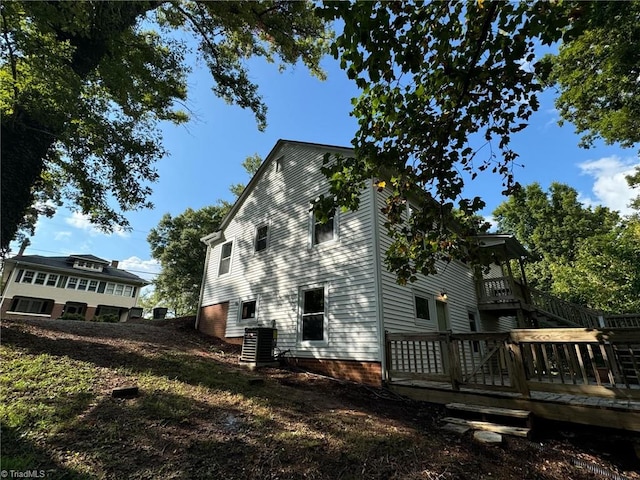 view of home's exterior featuring central AC unit and a wooden deck