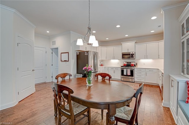 4240 Prestwick Xing, Winston-Salem, NC 27106 - dining space with light wood-style flooring, crown molding, and recessed lighting