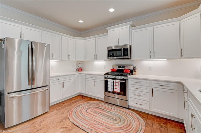 4240 Prestwick Xing, Winston-Salem, NC 27106 - kitchen with appliances with stainless steel finishes, white cabinetry, ornamental molding, light countertops, and tasteful backsplash