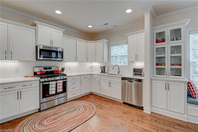4240 Prestwick Xing, Winston-Salem, NC 27106 - kitchen featuring appliances with stainless steel finishes, white cabinetry, a sink, decorative backsplash, and light countertops