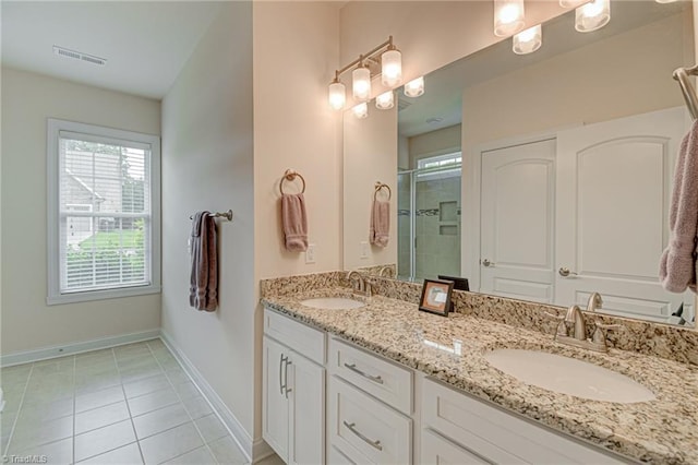 4240 Prestwick Xing, Winston-Salem, NC 27106 - full bath featuring double vanity, a stall shower, baseboards, and tile patterned floors