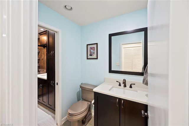 bathroom with recessed lighting, toilet, and vanity