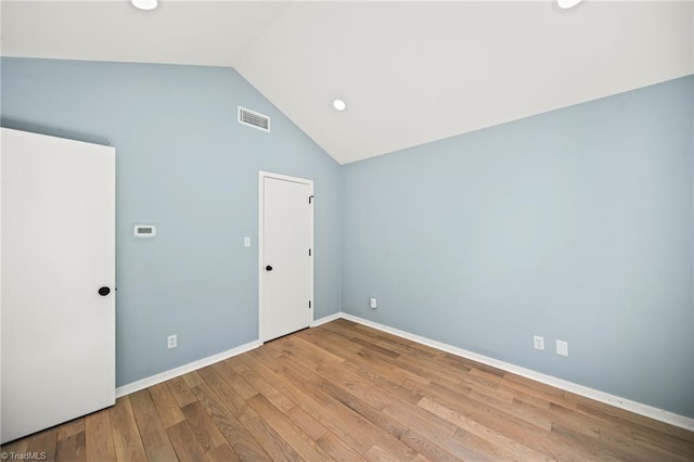 unfurnished bedroom featuring visible vents, high vaulted ceiling, baseboards, and wood finished floors