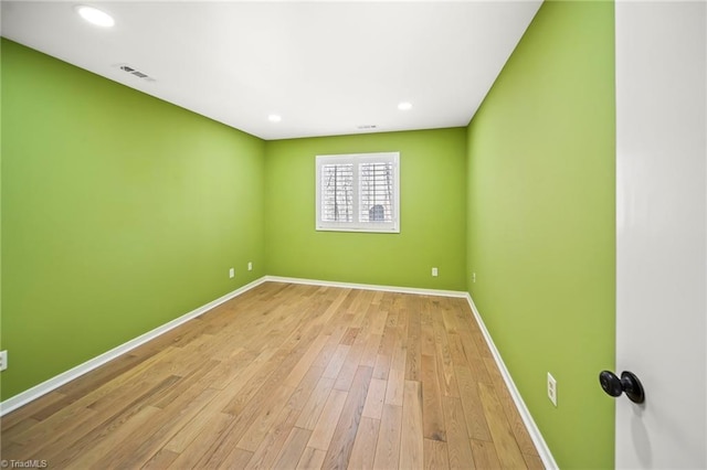 empty room with visible vents, recessed lighting, baseboards, and wood finished floors