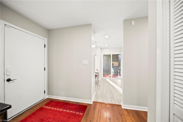 entryway featuring recessed lighting, baseboards, and wood finished floors