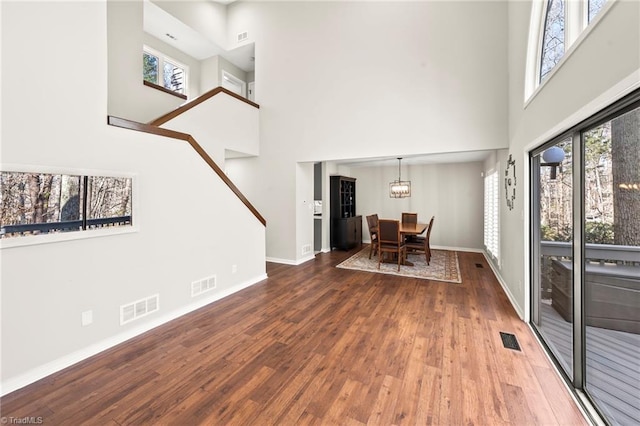 interior space with wood finished floors, visible vents, and baseboards