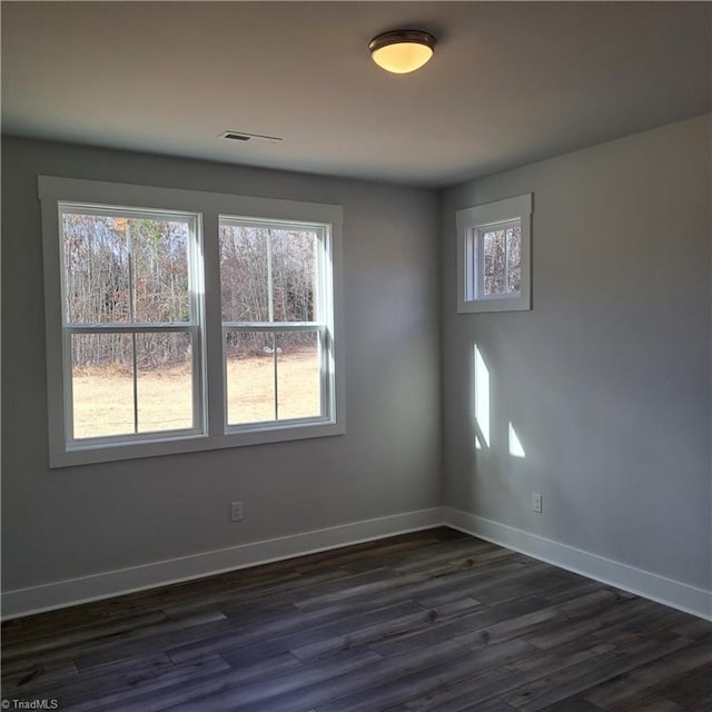 unfurnished room featuring dark hardwood / wood-style flooring