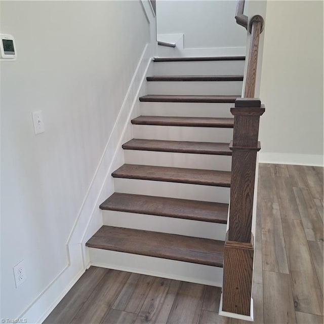 stairs featuring wood-type flooring