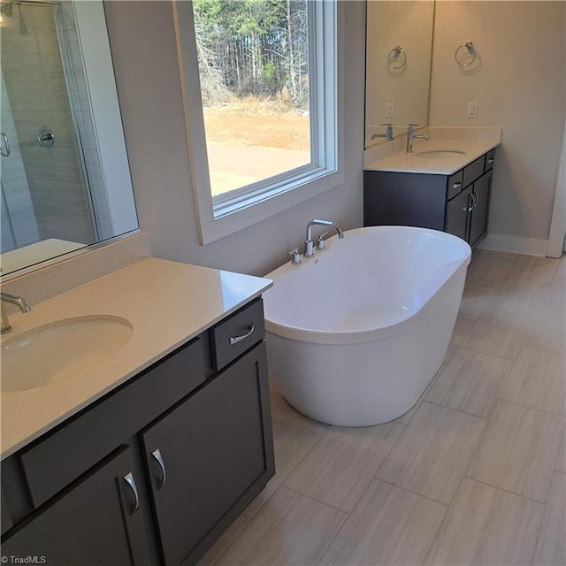 bathroom with vanity and separate shower and tub