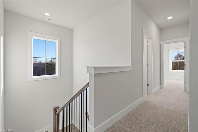 hallway featuring light carpet