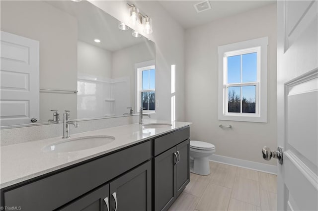 bathroom featuring a shower, toilet, and vanity