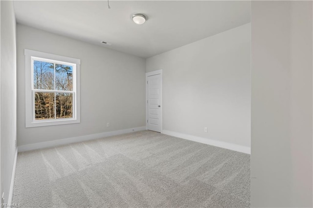 empty room featuring light colored carpet