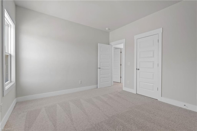 carpeted empty room featuring plenty of natural light