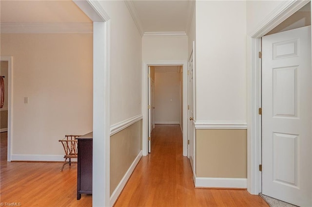 hallway featuring light hardwood / wood-style flooring and ornamental molding