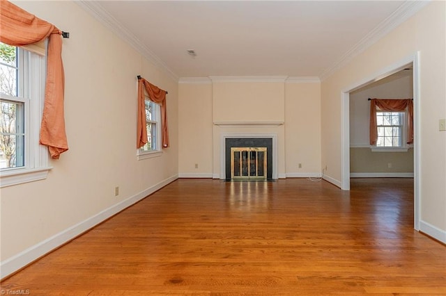 unfurnished living room with light hardwood / wood-style flooring, plenty of natural light, and crown molding