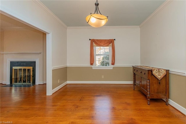 unfurnished dining area with light hardwood / wood-style flooring and crown molding