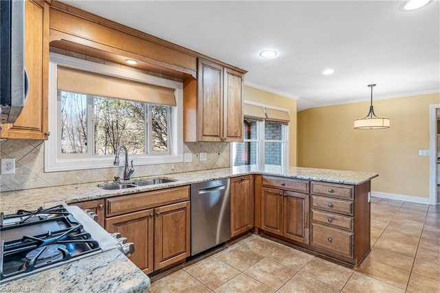 kitchen with sink, crown molding, decorative light fixtures, appliances with stainless steel finishes, and kitchen peninsula