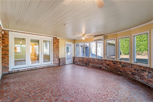 unfurnished sunroom featuring a wall unit AC, french doors, and ceiling fan