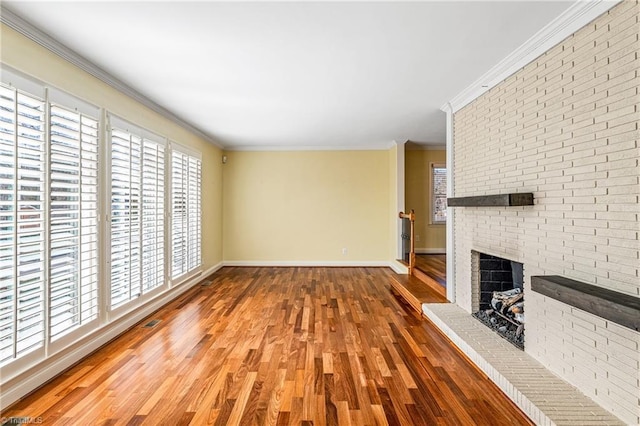 unfurnished living room with crown molding, wood-type flooring, and a fireplace