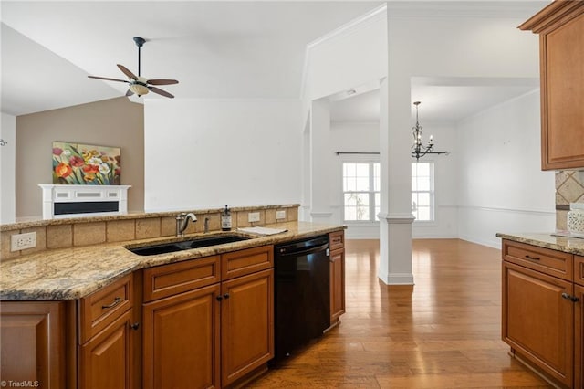 kitchen featuring a sink, ceiling fan with notable chandelier, black dishwasher, open floor plan, and vaulted ceiling