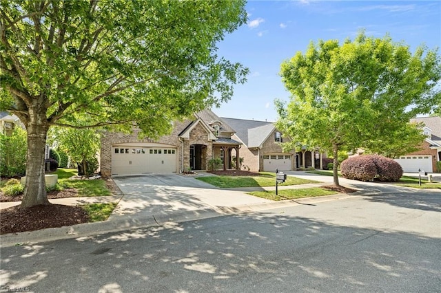 view of front facade with an attached garage, concrete driveway, and stone siding