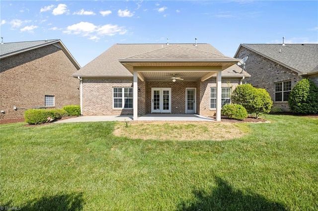 back of property featuring a yard, a patio, a ceiling fan, and brick siding