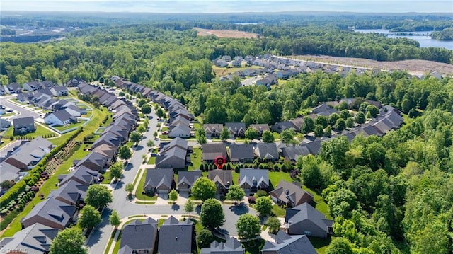 drone / aerial view with a view of trees and a residential view