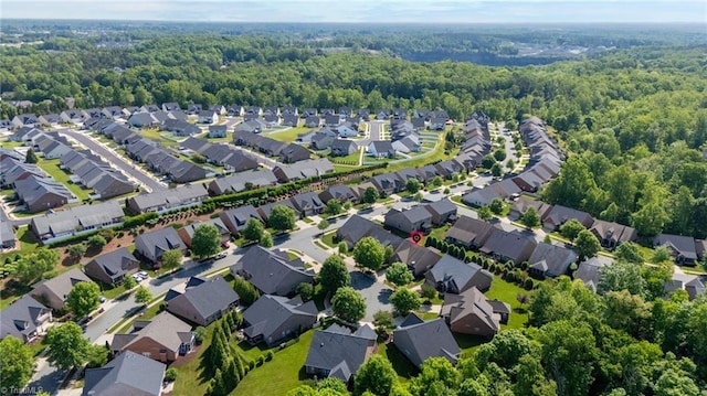 drone / aerial view with a residential view and a forest view