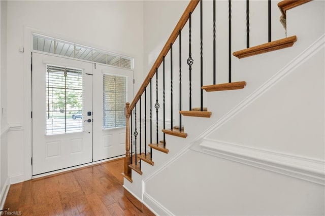 foyer entrance featuring stairway and wood finished floors