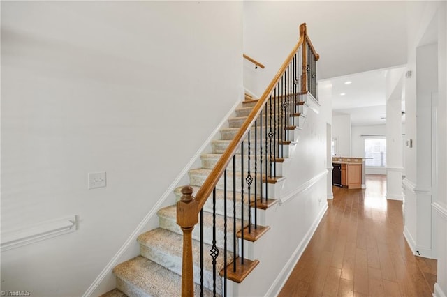 stairs featuring recessed lighting and hardwood / wood-style floors