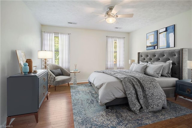 149 Royal View Dr Unit 1, Pinnacle, NC 27043 - bedroom with multiple windows, wood finished floors, a textured ceiling, and ceiling fan