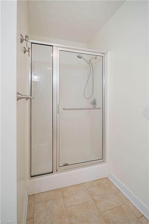 149 Royal View Dr Unit 1, Pinnacle, NC 27043 - bathroom featuring a stall shower, baseboards, and tile patterned flooring