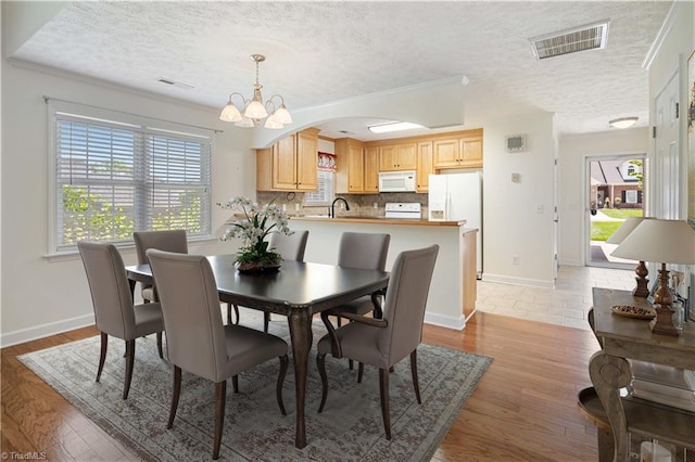 149 Royal View Dr Unit 1, Pinnacle, NC 27043 - dining space with a textured ceiling, plenty of natural light, a chandelier, baseboards, and crown molding
