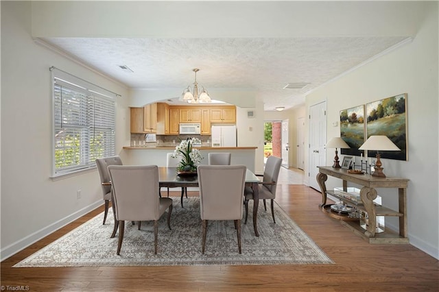149 Royal View Dr Unit 1, Pinnacle, NC 27043 - dining room with plenty of natural light, a chandelier, crown molding, baseboards, and dark wood-type flooring