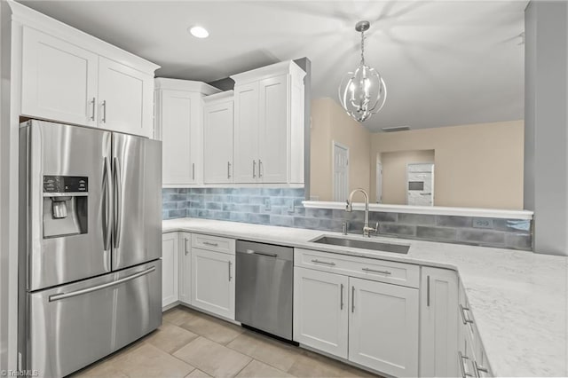 kitchen with white cabinetry, sink, appliances with stainless steel finishes, and tasteful backsplash