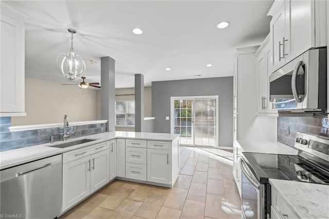 kitchen with white cabinets, appliances with stainless steel finishes, and sink