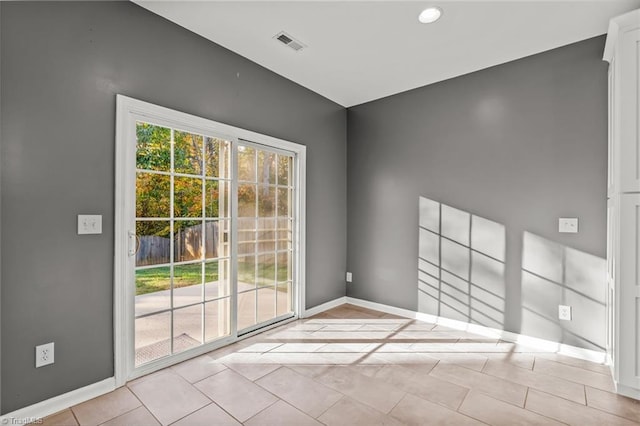 spare room featuring light tile patterned floors